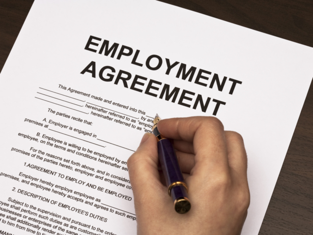 female hands filling out employment agreement contract