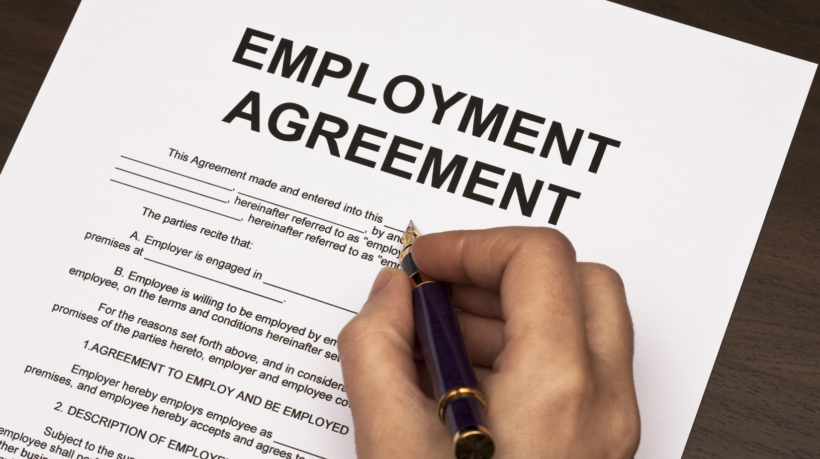 female hands filling out employment agreement contract